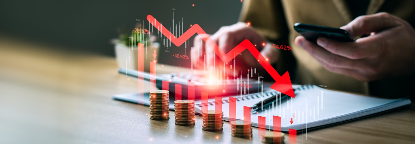 businessman with falling financial graph chart due to global recession.
