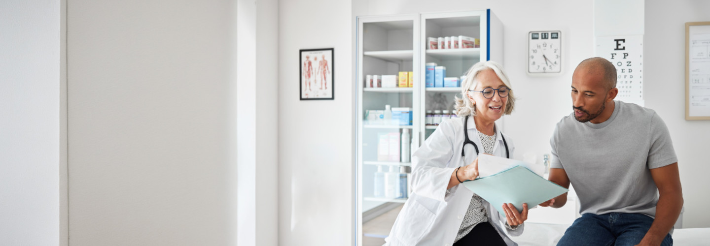 Female doctor treating male adult patient