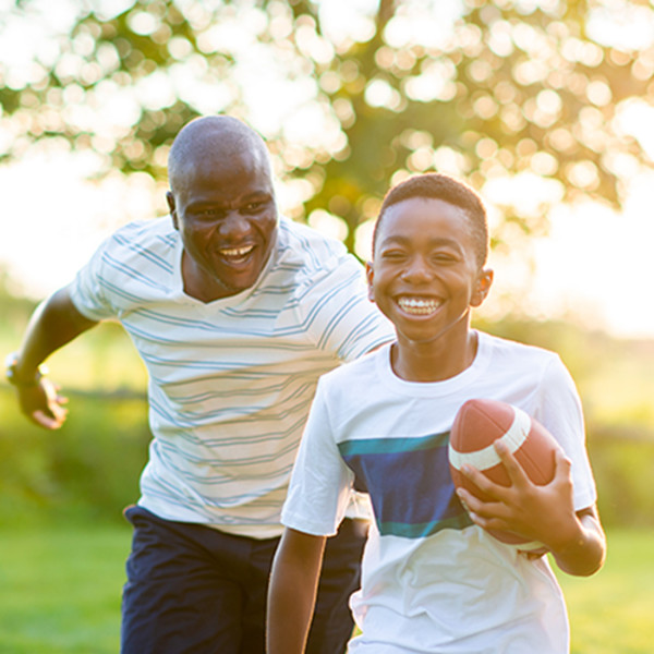 Father and son playing football