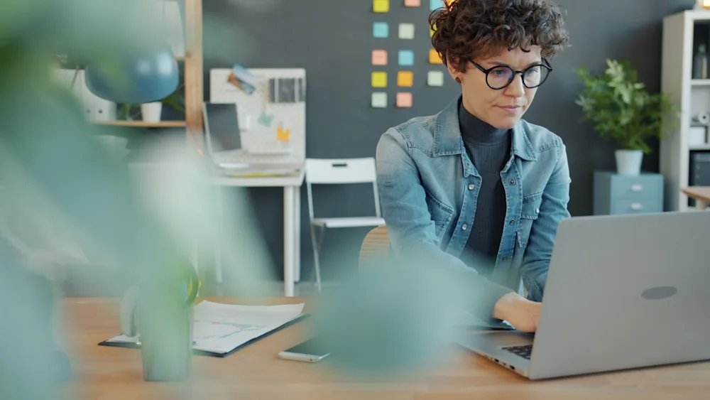 Small business owner researching AI automation opportunities on laptop