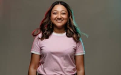 Young person in pink top smiling