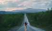 Man skateboarding on a highway in Lapland