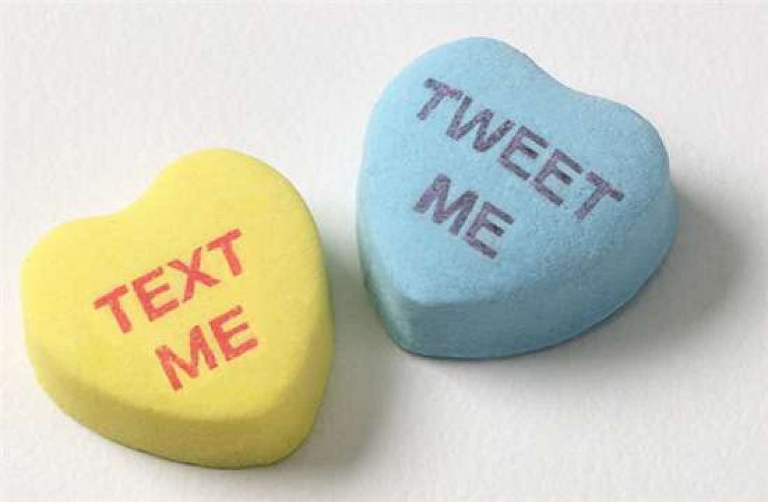 Candy Hearts that say "Text me" and "Tweet Me"