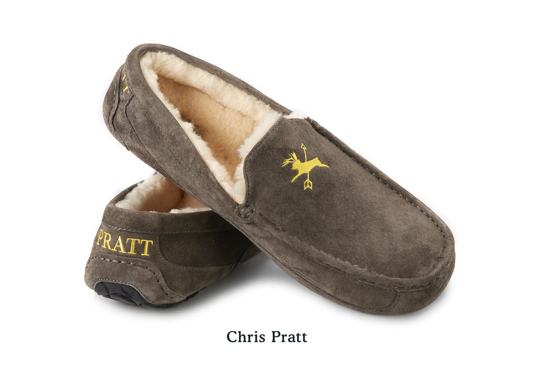 A pair of UGG Slippers for Chris Pratt with embroidery of a deer crossed with an arrow and the name "Pratt" on the heel