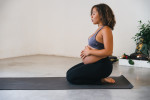 Pregnancy workouts: pregnant woman holding her belly