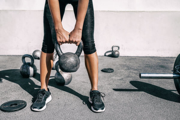 How to get stronger: person working out using a kettlebell