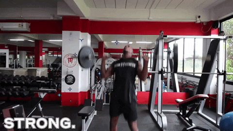 Man doing some barbell overhead press GIF