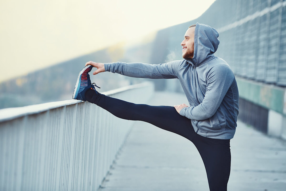 Should I get a personal trainer: runner stretching his leg