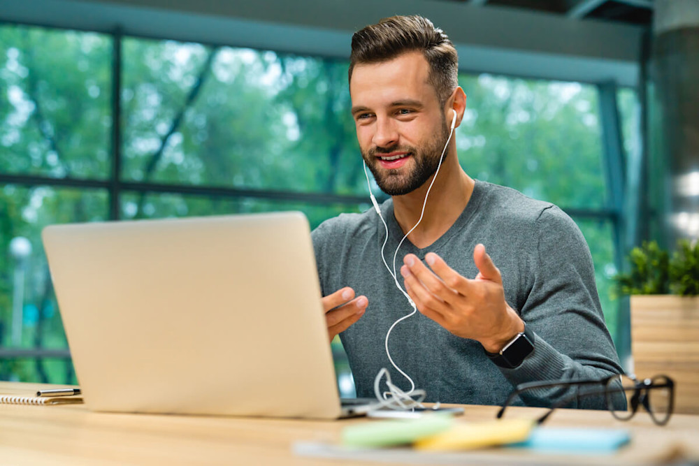 Online nutrition coach wearing earphones while on a video call