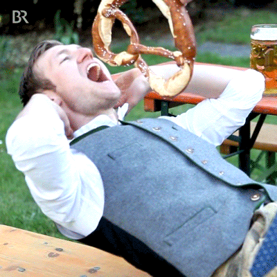 How to lose 20 pounds: Man doing a sit-up to eat a pretzel