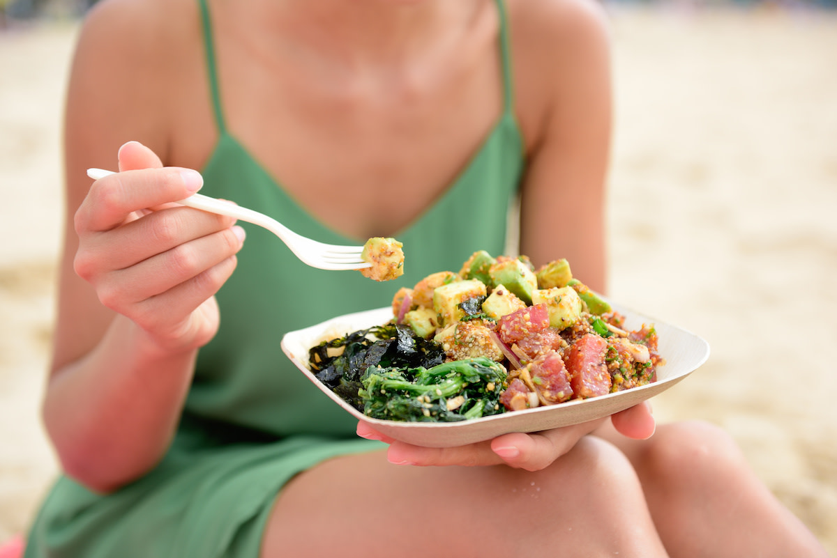 How to lose 20 pounds: Woman eating poke bowl salad lunch