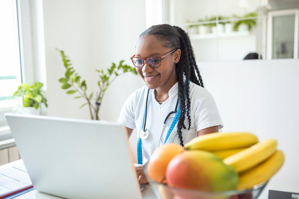 Online nutrition coach happily typing