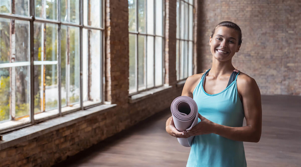 Woman holding a yoga mat