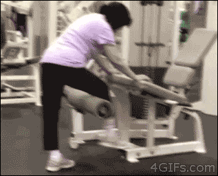 Person using a leg extension machine GIF