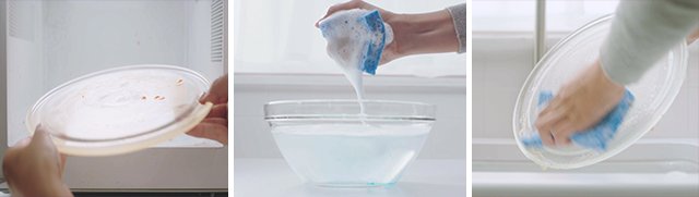 Hands removing glass tray from microwave hand squeezing soapy sponge above soapy water bowl and hand cleaning microwave glass tray with sponge