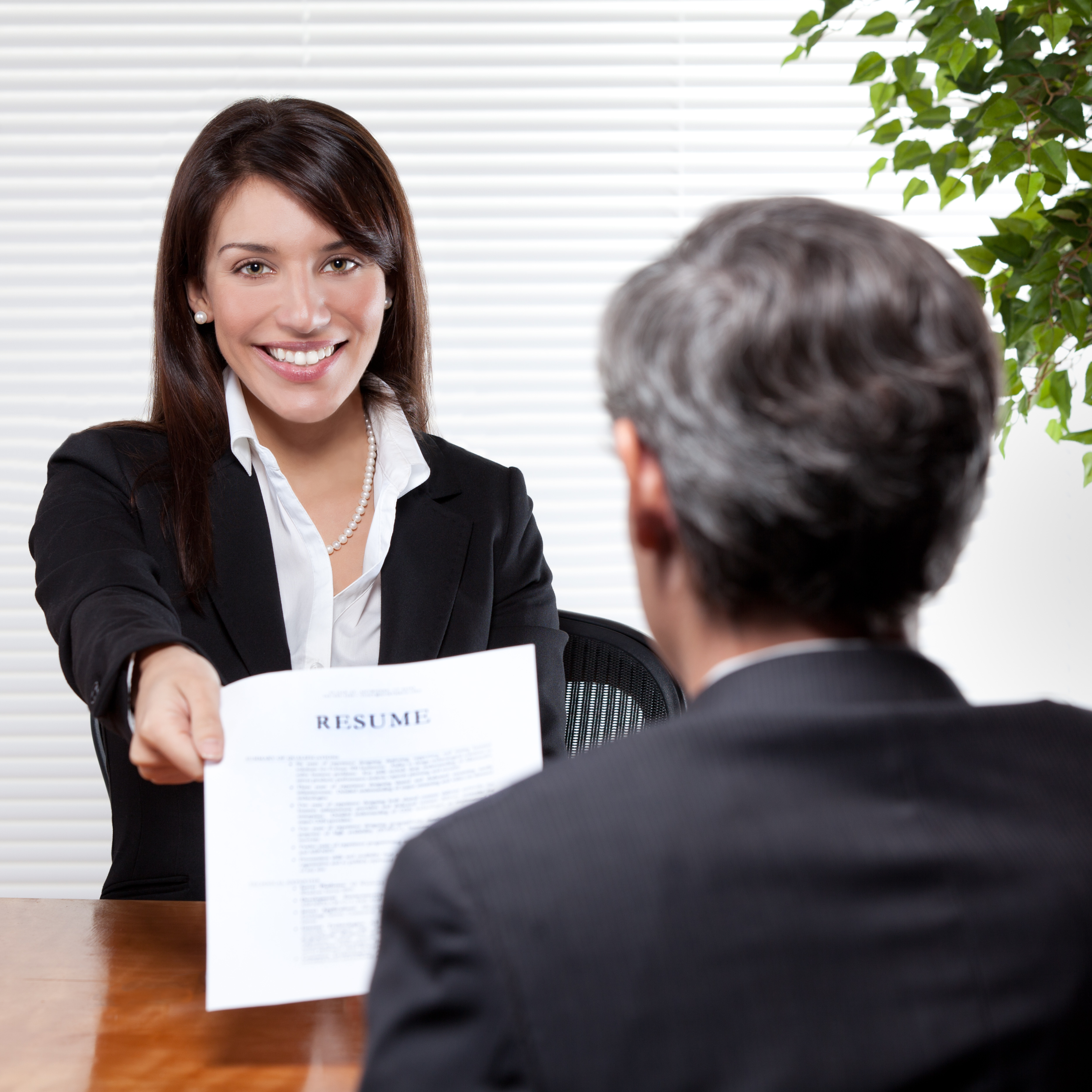 girl giving her resume to the man