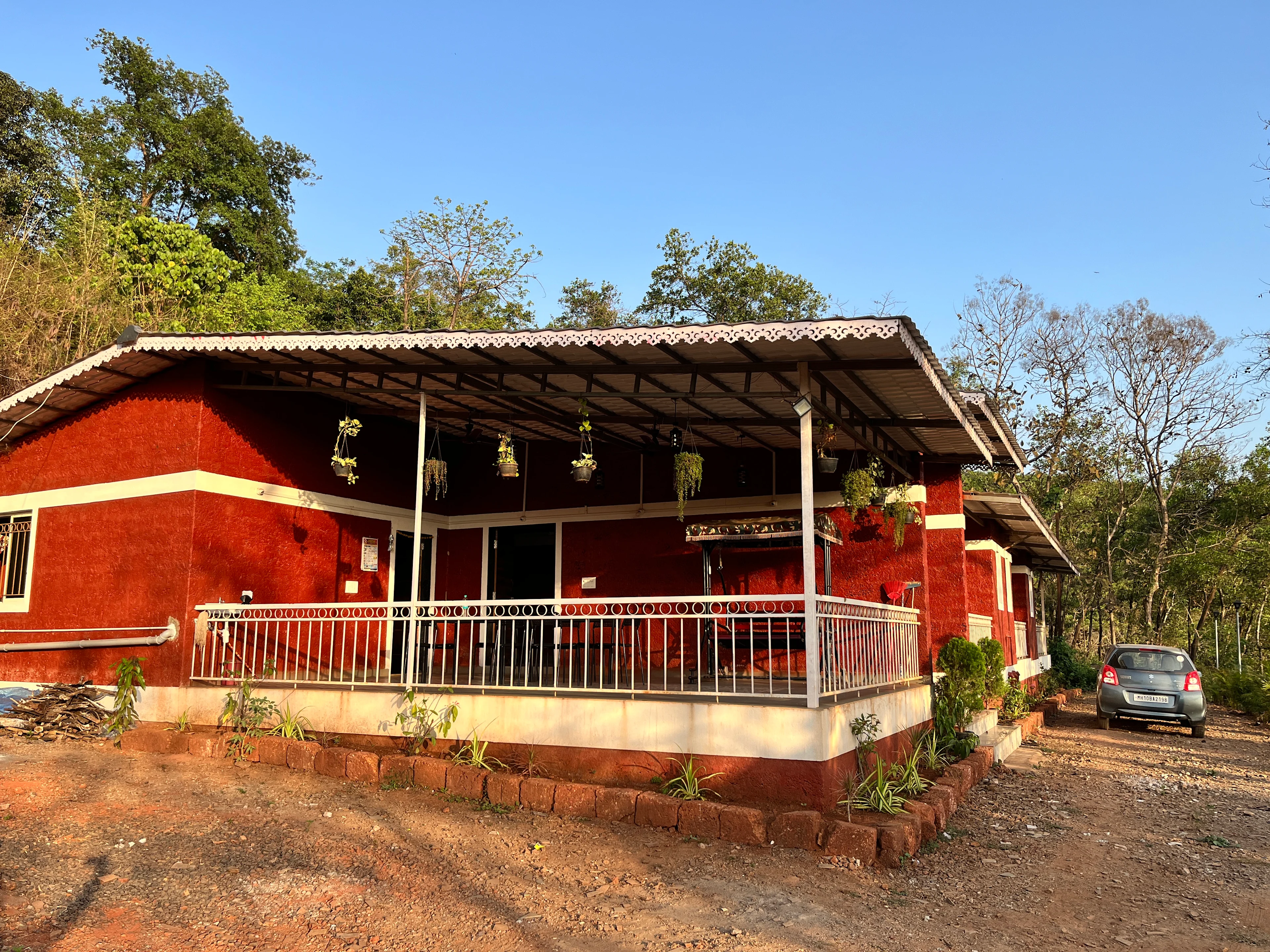 Panoramic view of the Konkan landscape surrounding Blossom Retreat farmstay — Western Ghats, paddy fields, and river in Chiplun, Maharashtra