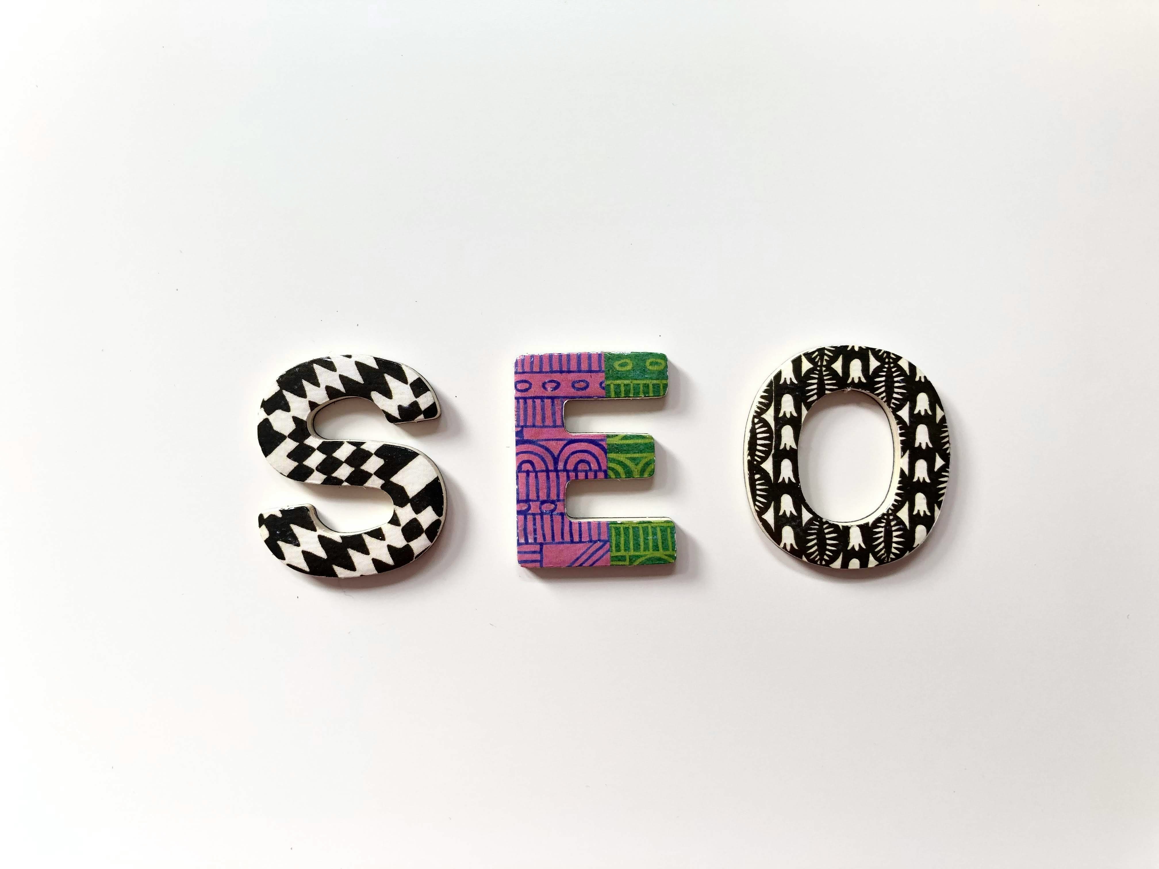Colorful decorative letters spelling 'SEO' on a white background; visual concept representing search engine optimization and AI-driven digital visibility.