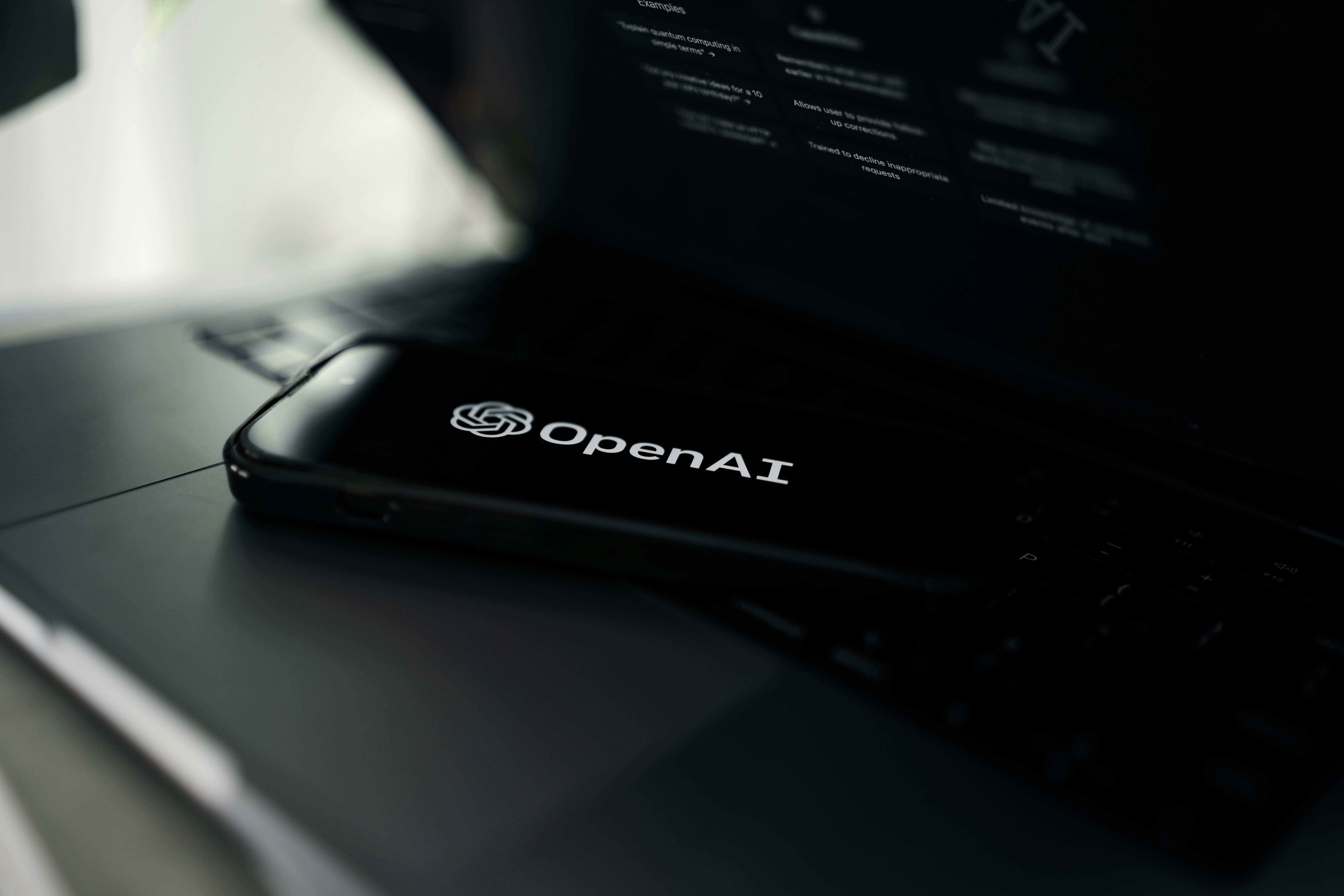 Smartphone displaying the OpenAI logo placed on a laptop keyboard, symbolizing the growing integration of ChatGPT technology into digital tools and the future of AI-driven advertising.