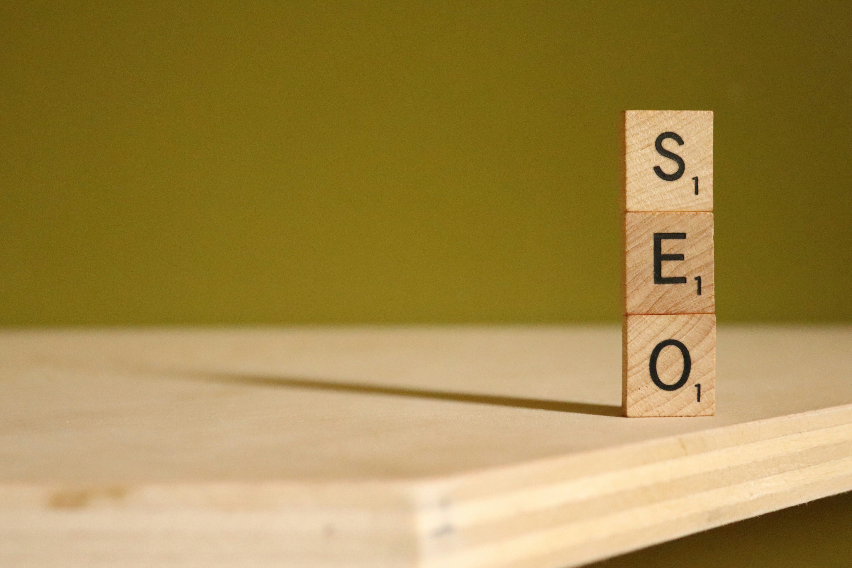 Wooden Scrabble blocks spelling SEO, illustrating digital marketing and AI SEO optimisation for travel brands.