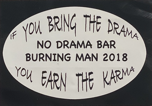 Oval sticker on black background. White oval reads: "If you bring the drama / No Drama Bar / Burning Man 2018 / You earn the karma".