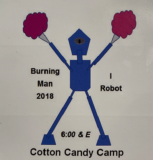 Simple illustrated robot with pom-poms and one eye, with text “Burning Man 2018,” “I Robot,” and “Cotton Candy Camp, 6:00 & E.”