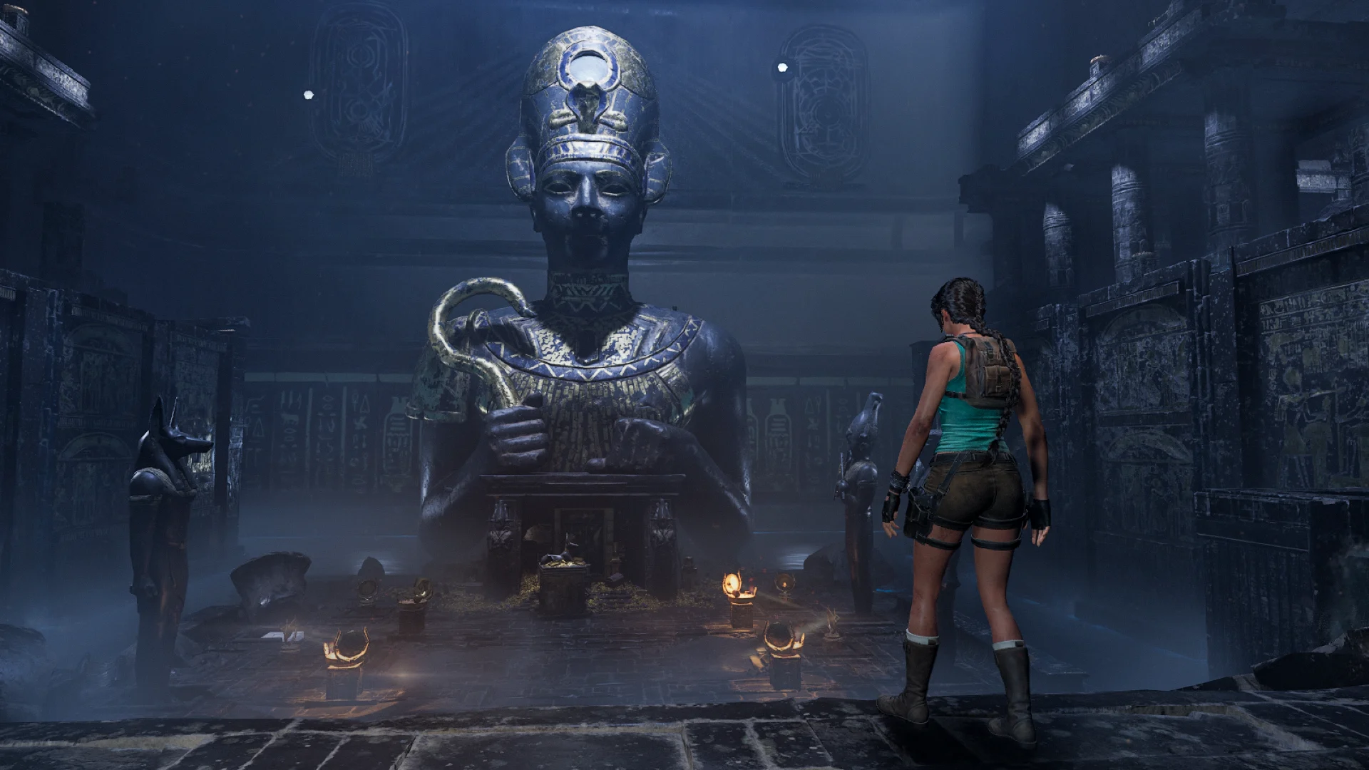 Female adventurer standing before a massive Egyptian pharaoh statue inside a dimly lit ancient temple chamber with hieroglyphic walls, stone columns, and atmospheric blue fog.
