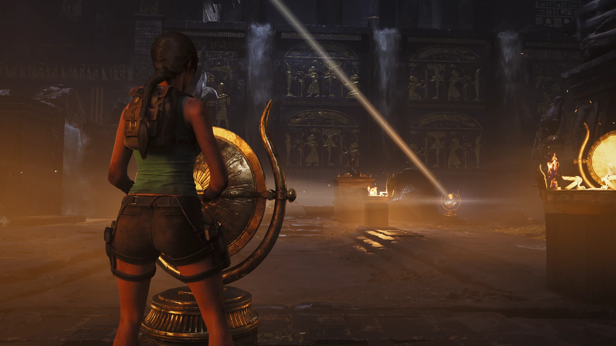 Female adventurer manipulates a large golden mirror in an ancient Egyptian temple. A dramatic light beam reflects across a dusty, torch-lit chamber with hieroglyphic relief carvings, solving an environmental puzzle.