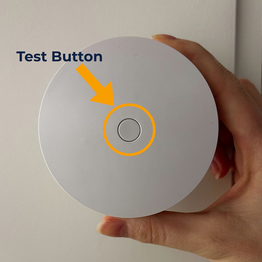 The front face of the Smoke & CO Alarm Listener, with a circle highlighting the Test Button located in the middle of the device.
