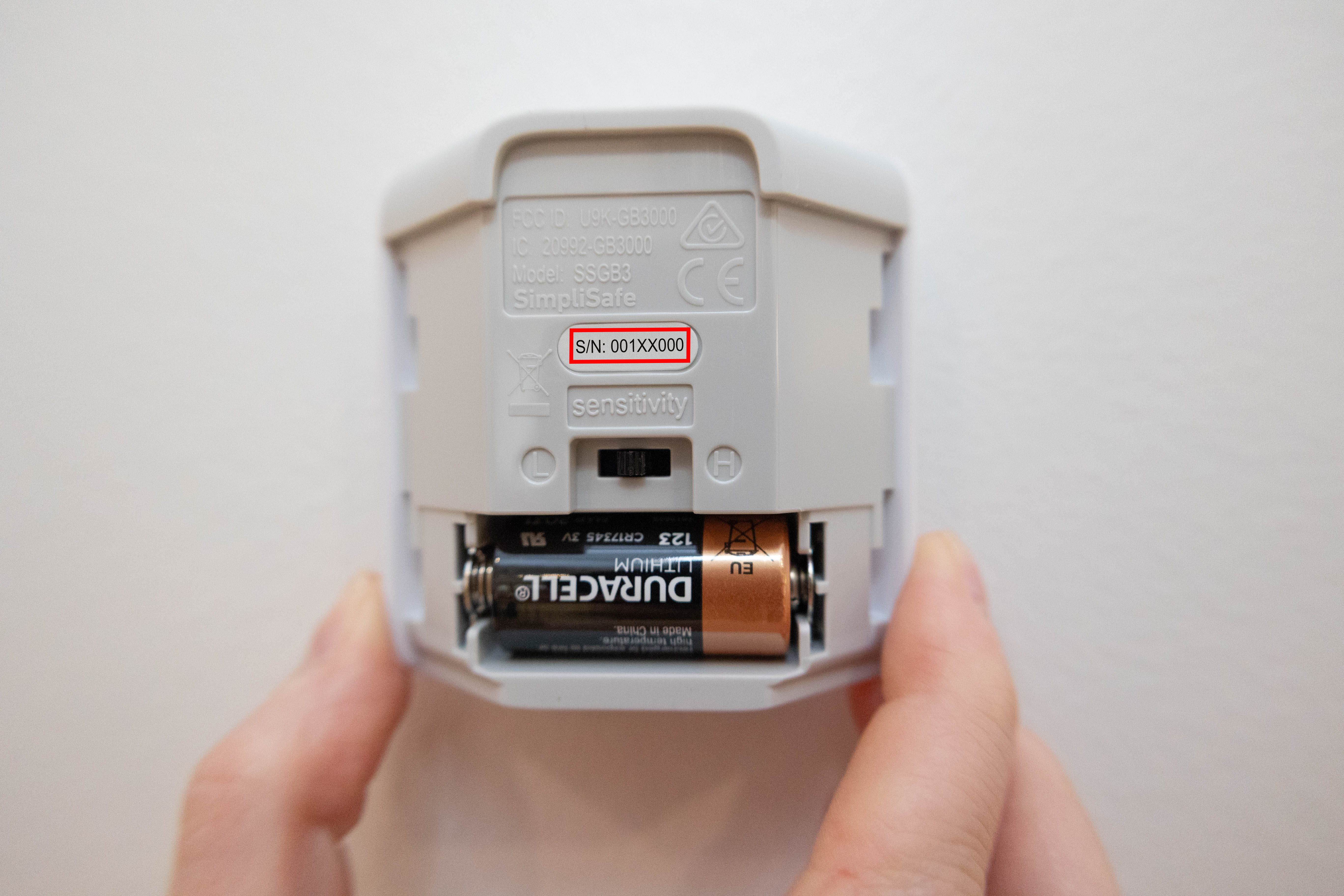 Slide off the backing of the Glassbreak Sensor to see the serial number