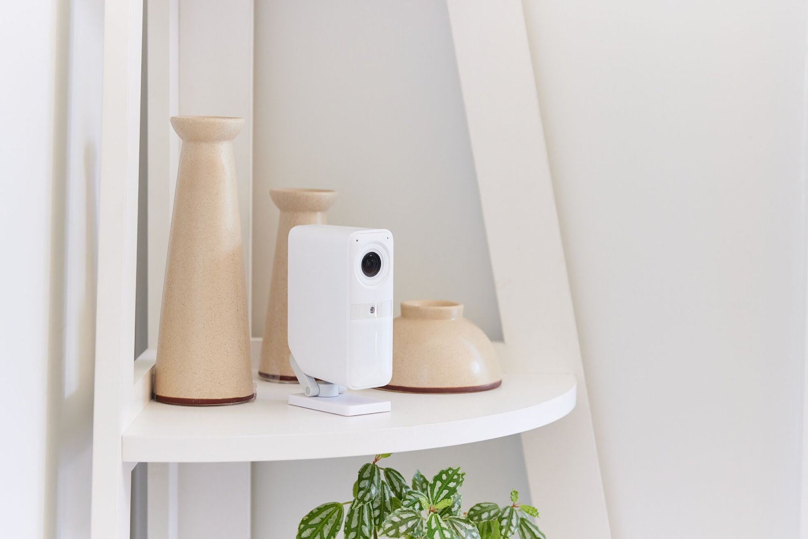 The Smart Alarm Wireless Indoor Security Camera placed on a shelf.