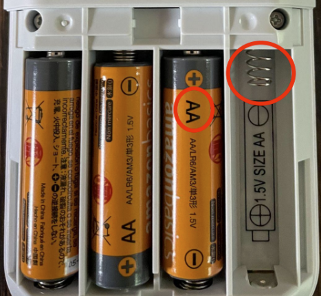 The Keypad's battery compartment, with the negative side of the battery touching the springs.