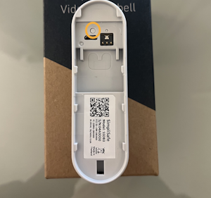 The back side of the Video Doorbell Pro, with the larger button on the left circled.