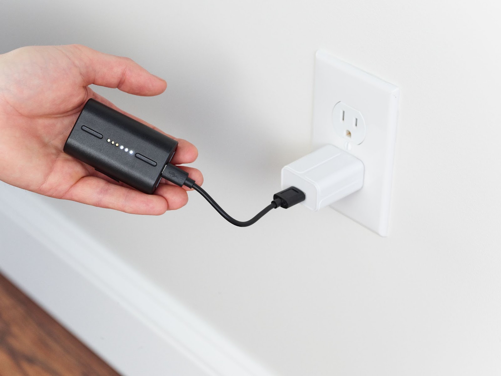 Charge Outdoor Camera battery by plugging it into a compatible power brick.