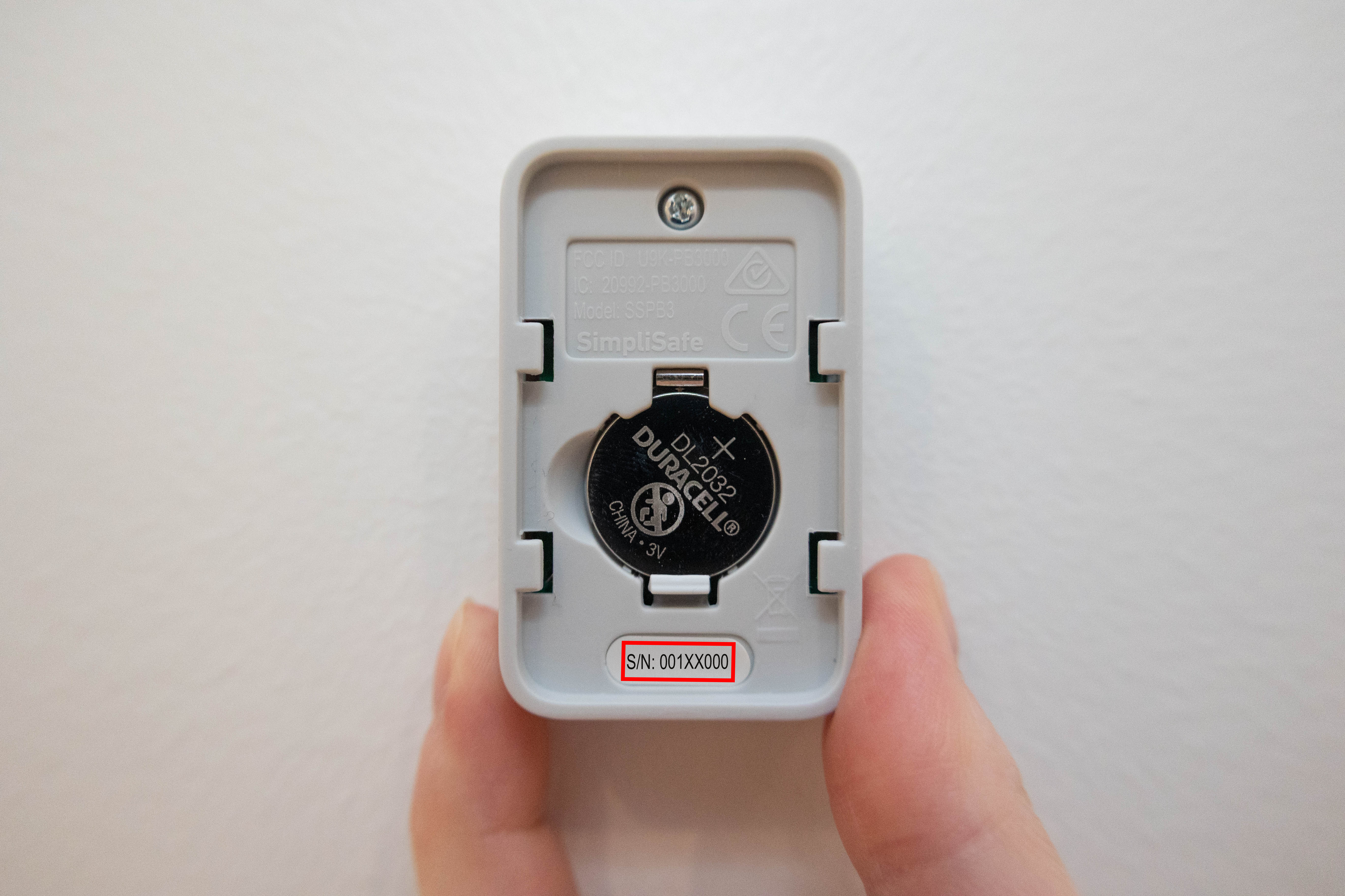 Slide the front of the Panic Button up and off its bracket to expose the serial number