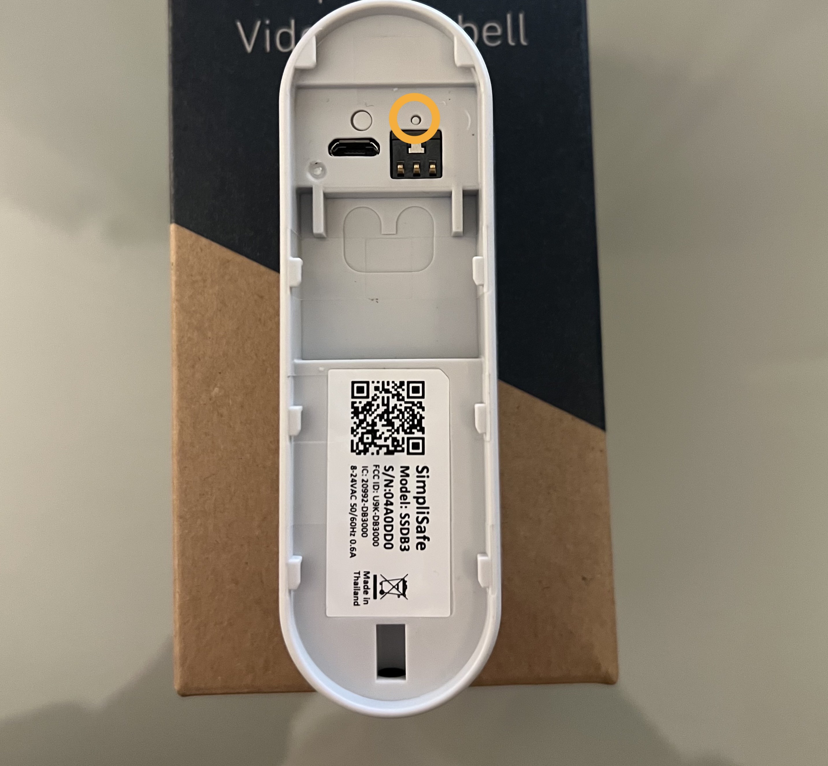 The back of the Video Doorbell Pro, with a circle around its small, factory reset button.