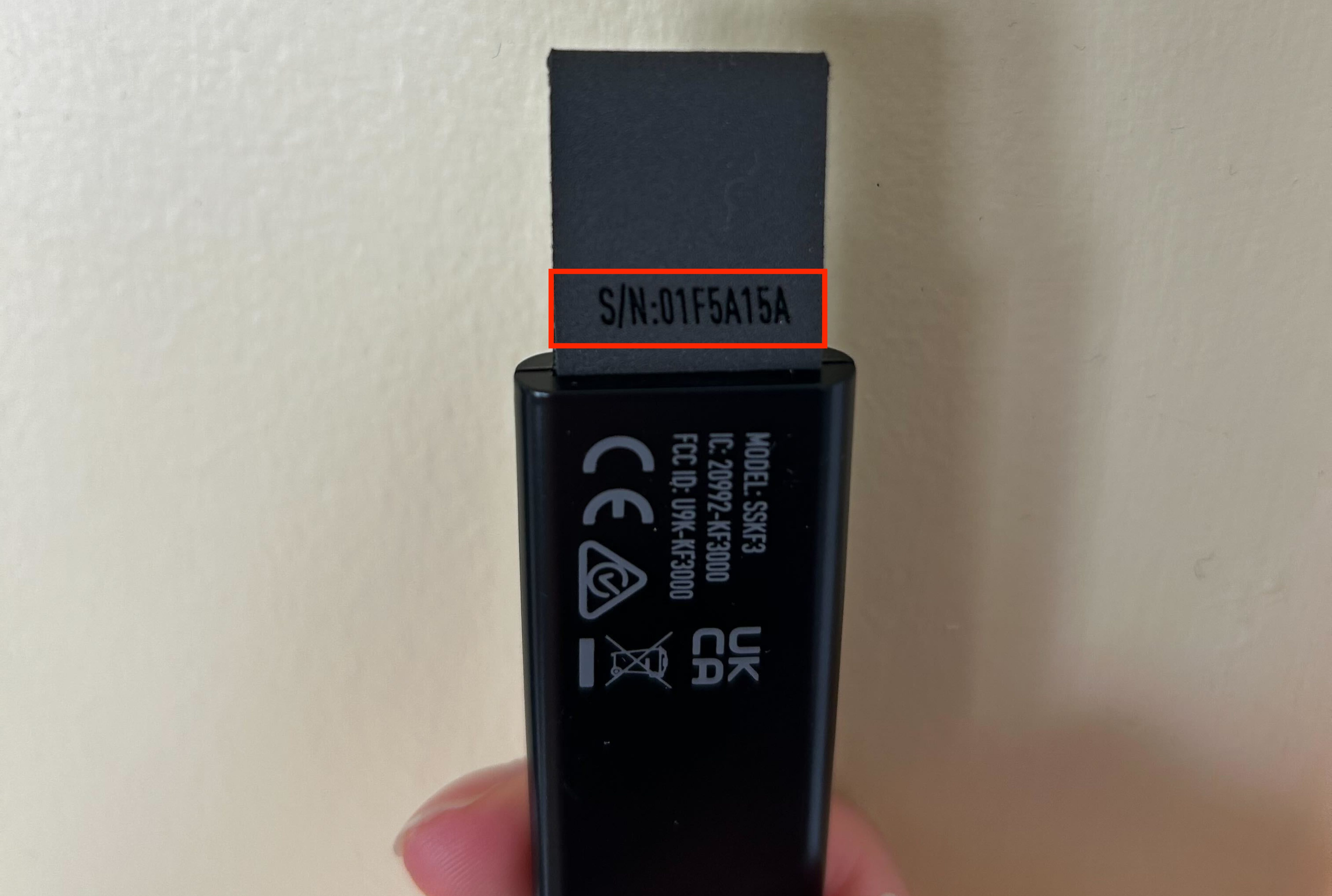 The tab on the Key Fob with a red rectangle highlighting the device's serial number.