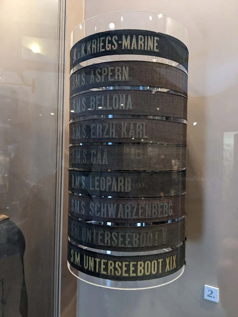 A stack of black sailors’ cap bands lettered with the names of Austro-Hungarian warships and submarines