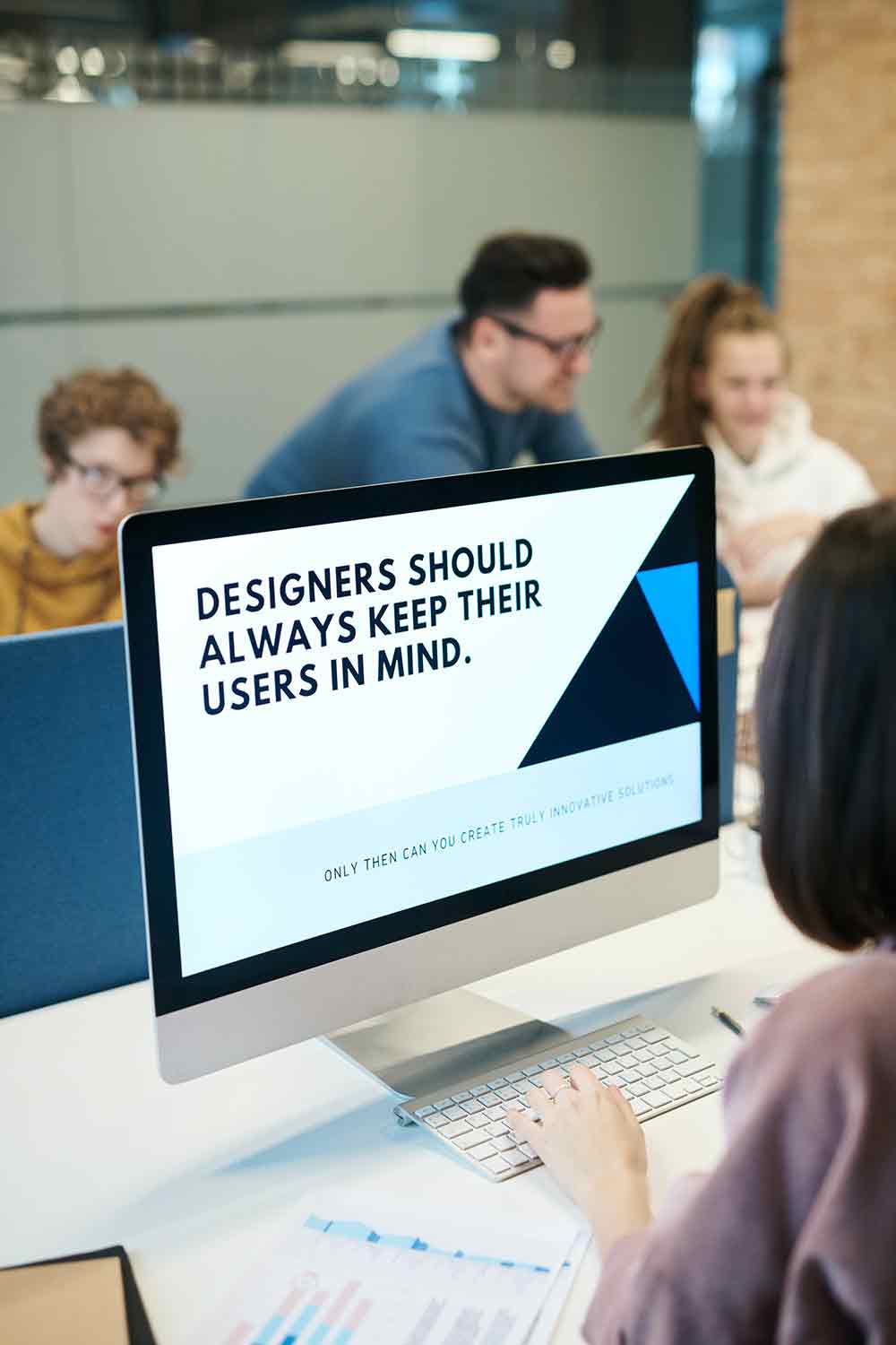 A monitor displaying the text "designers should always keep their users in mind."