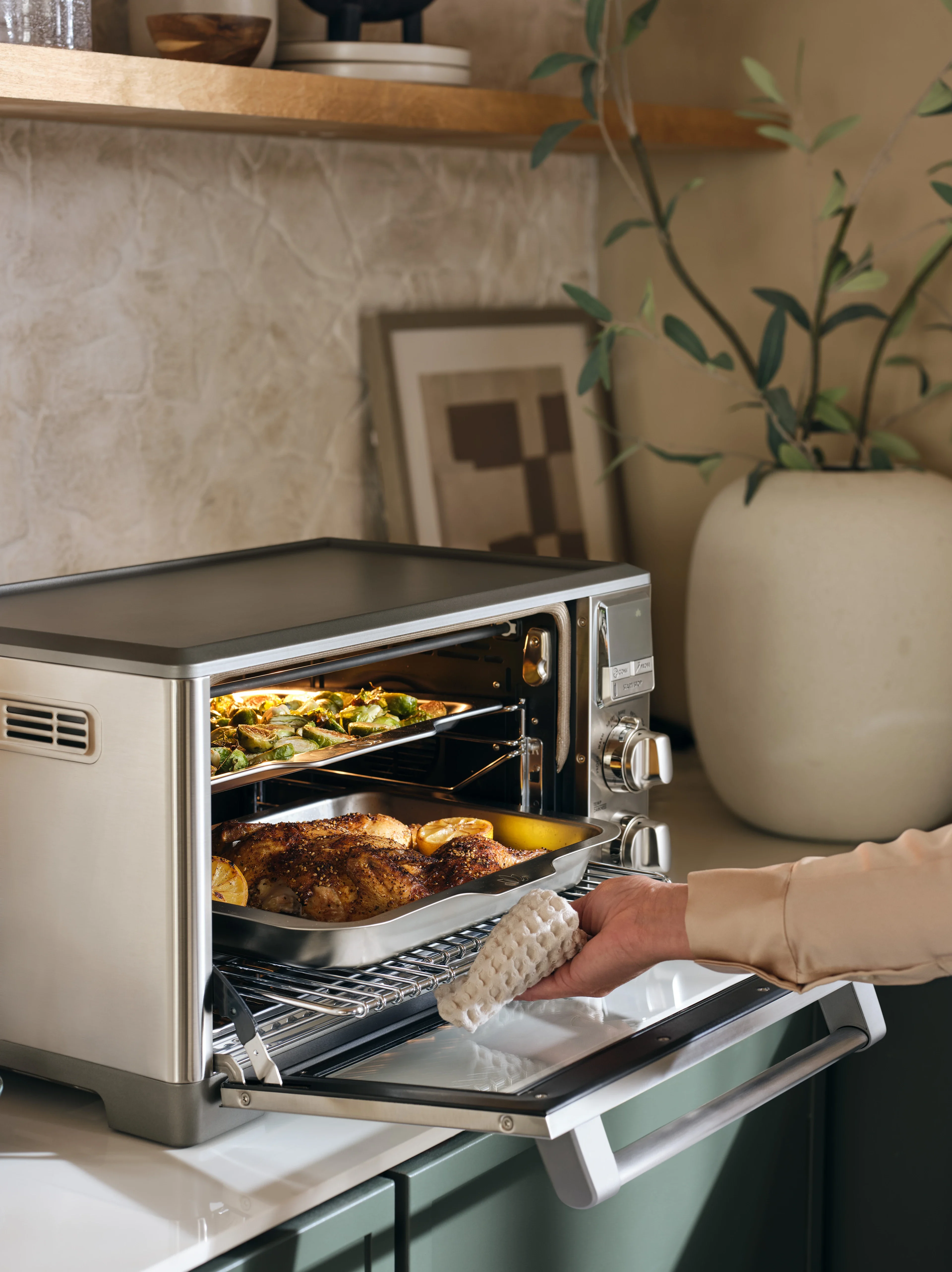 Person taking food out of the perfectionist™ air fry and convection oven model ltsco500