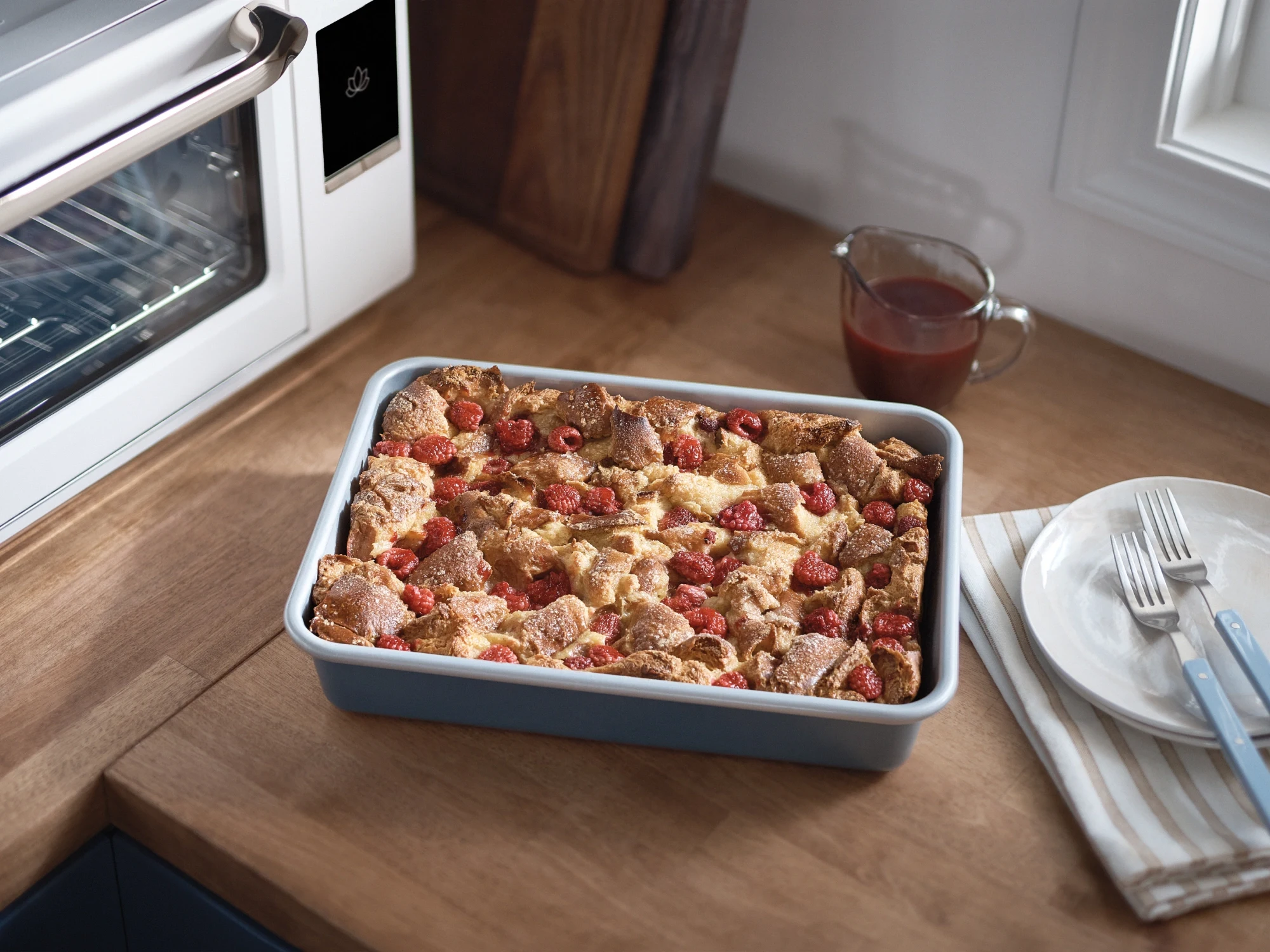 The Luminary oven in Alabaster with a baked raspberry French toast casserole in the bake tray