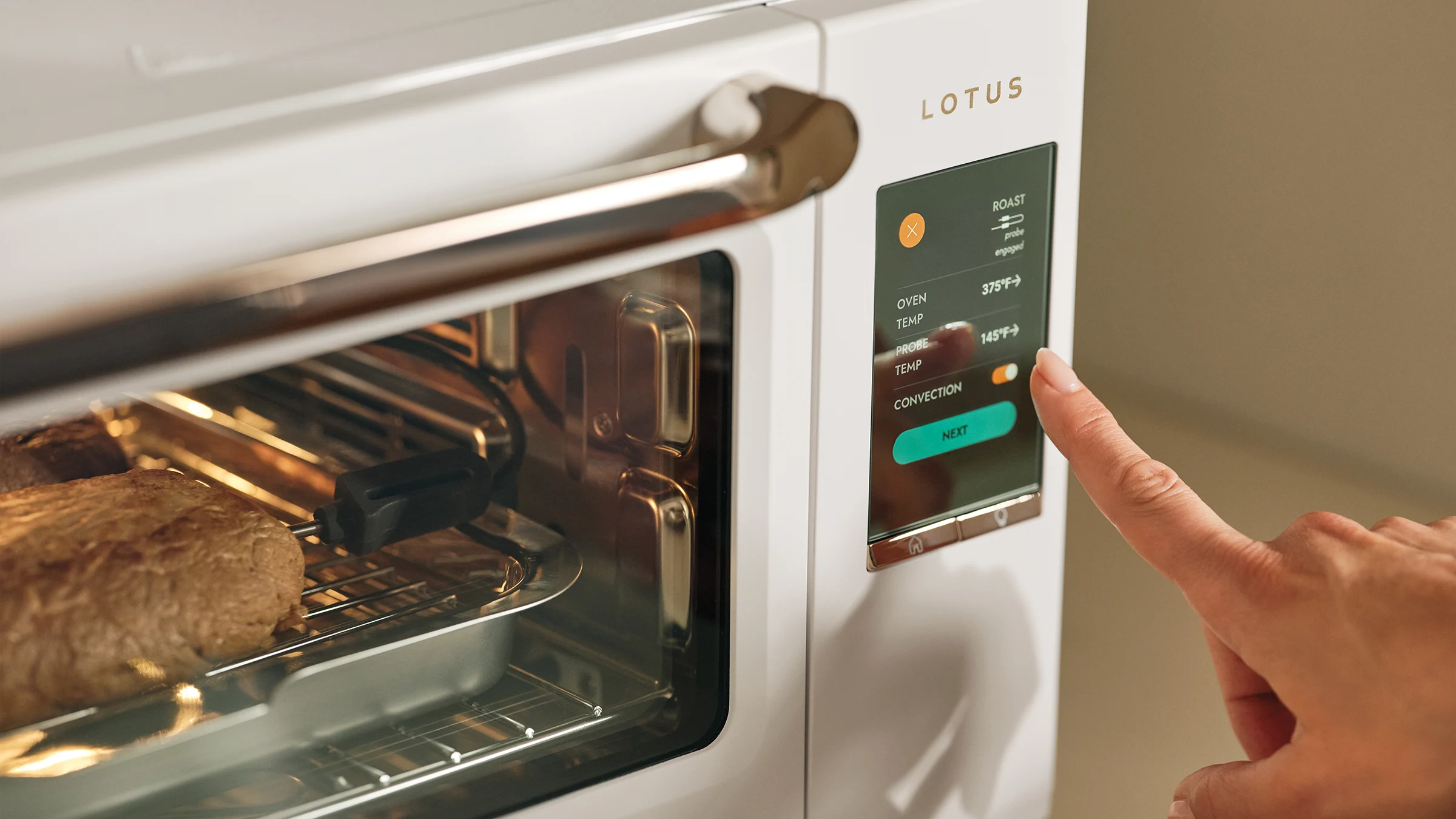 The Luminary oven in Alabaster roasting meat with the temperature probe inserted, hand adjusting the touchscreen