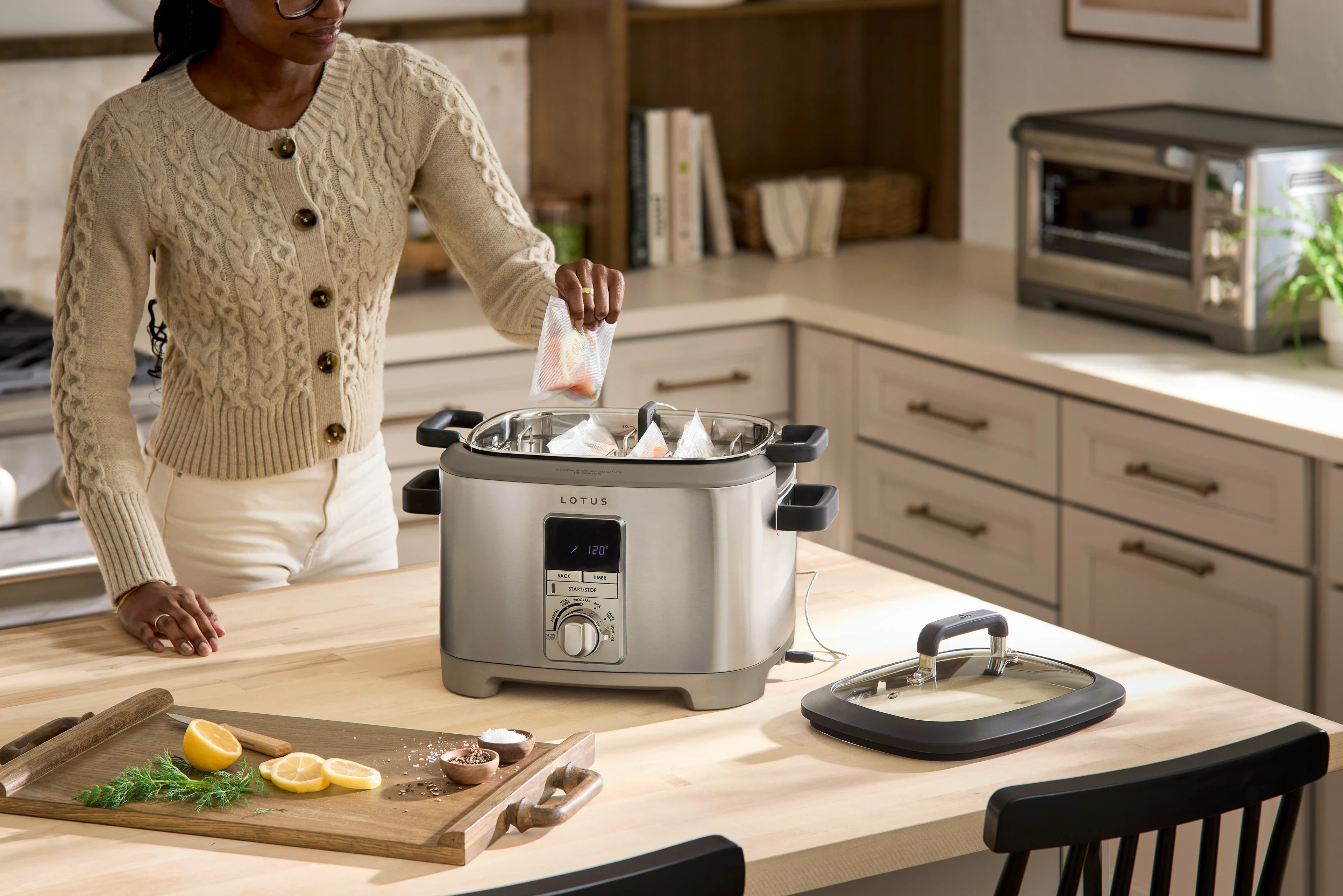 person using cooking with the sous™ advanced multi function cooker with tri ply dutch oven model ltssc500