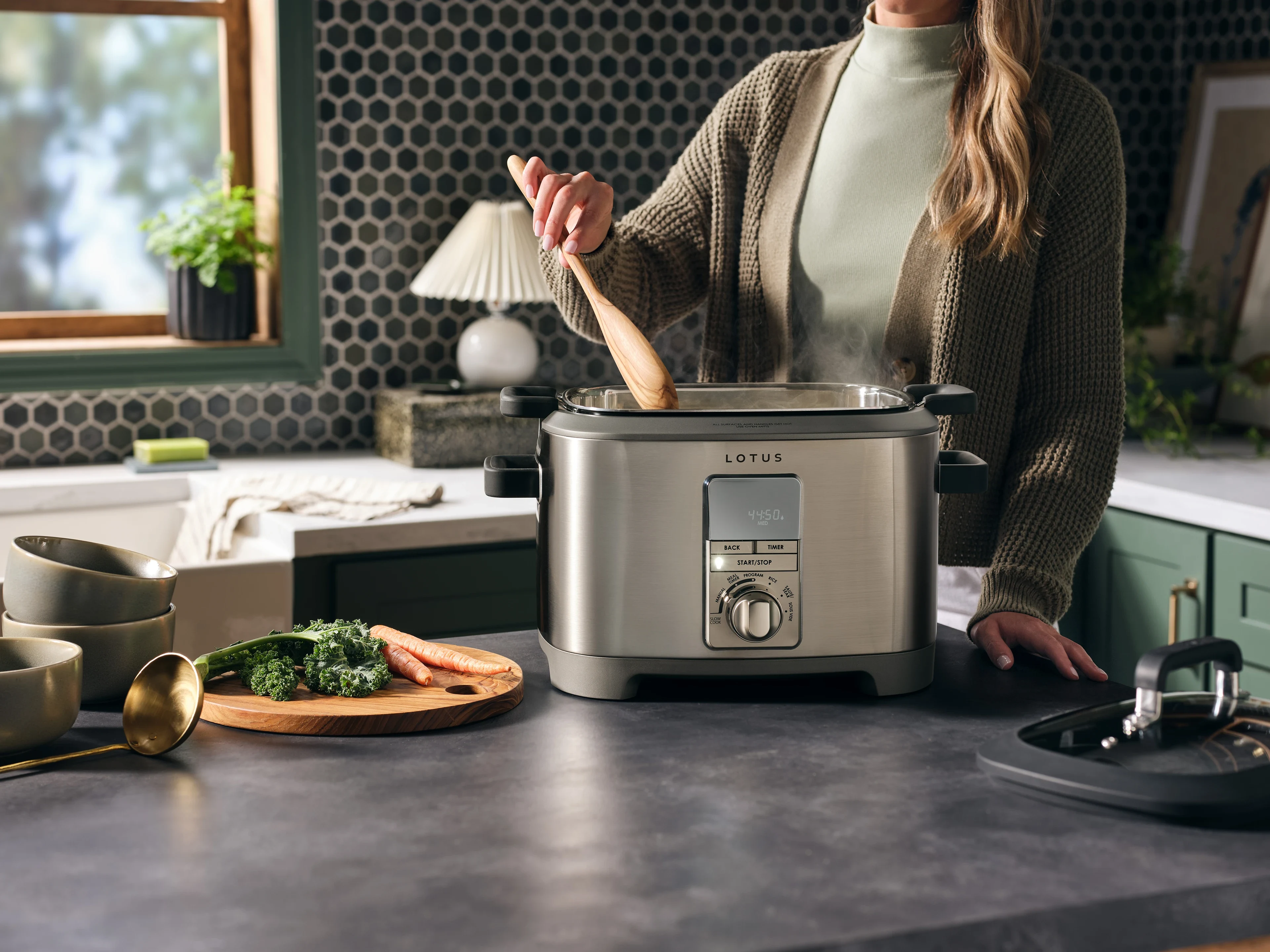 Person cooking with the sous™ advanced multi function cooker with tri ply dutch oven model ltssc500