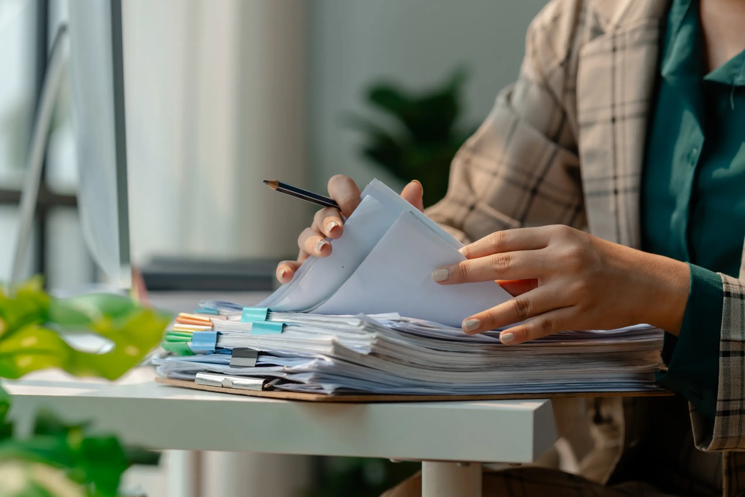 Checklist of documents needed to apply for a private student loan next to a laptop