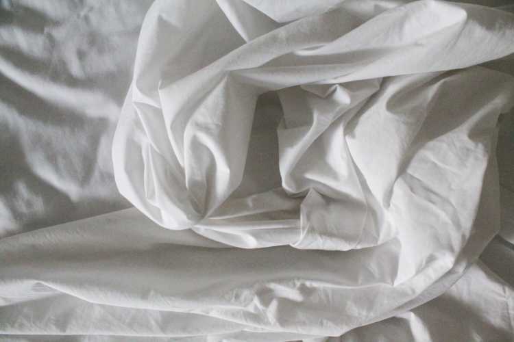 Sheets in a bed to accompany article about sleep