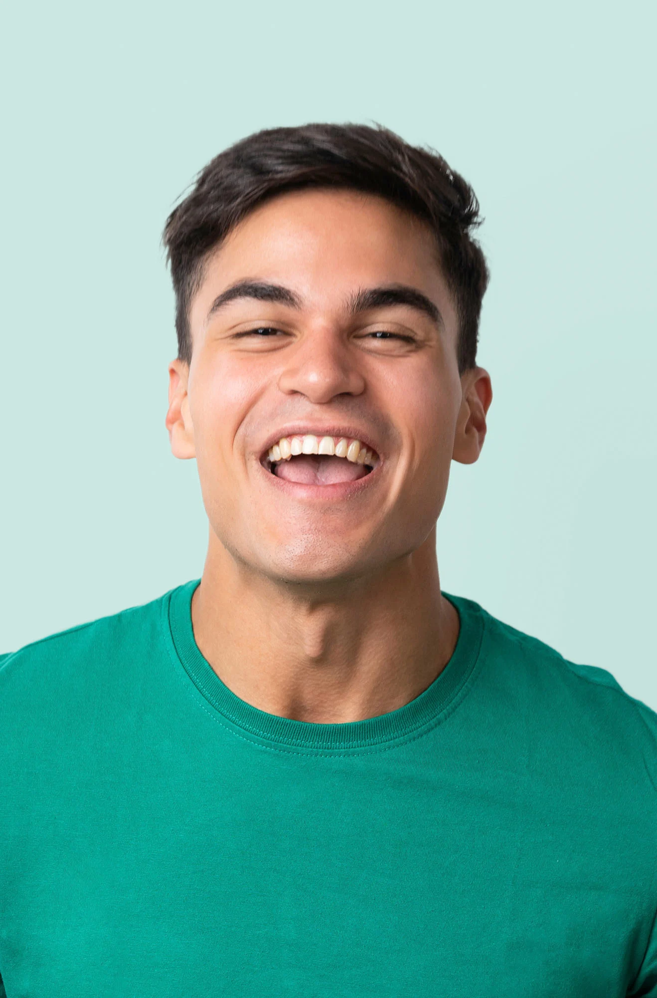 Man in green shirt smiling