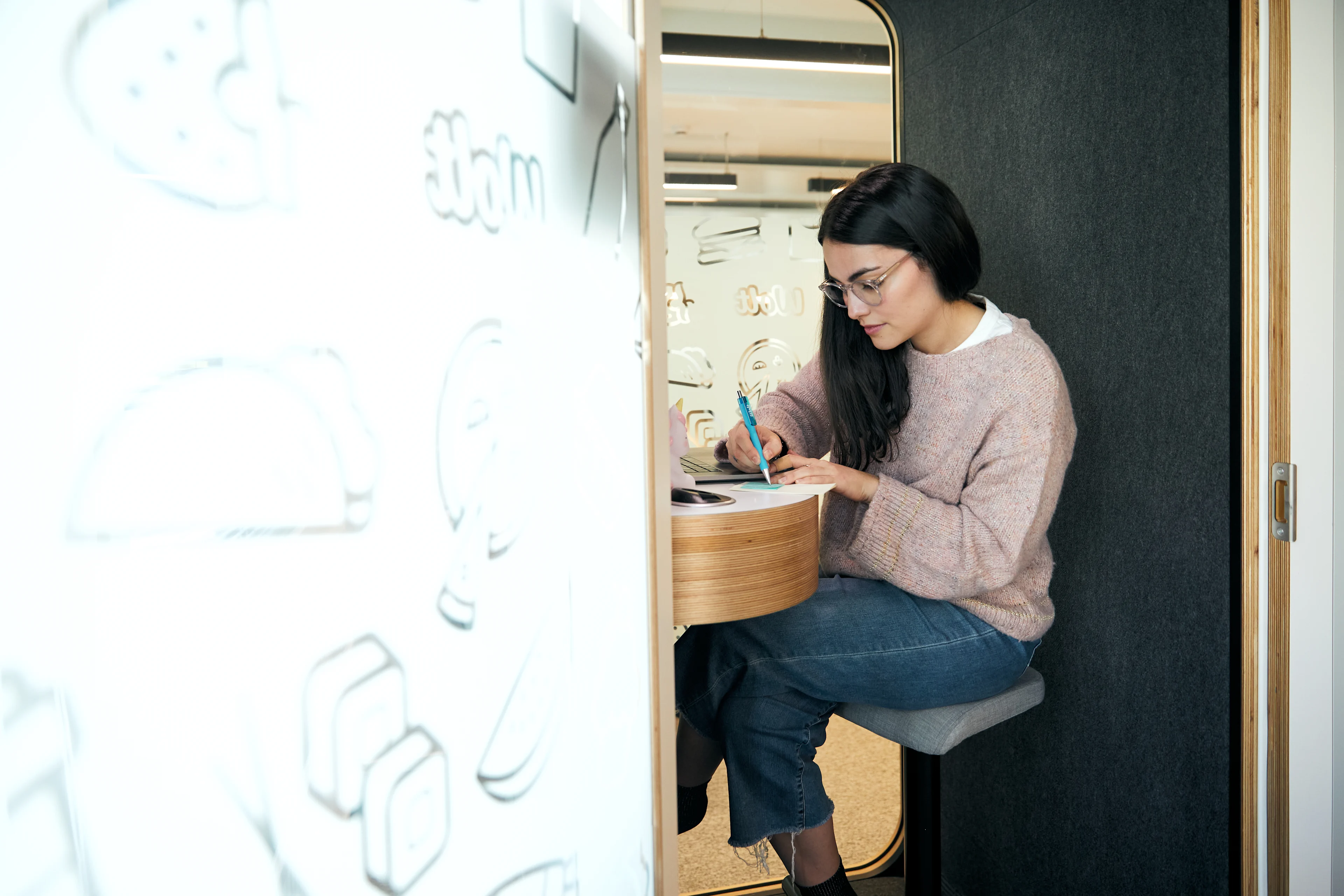 HQ - woman on laptop in a booth