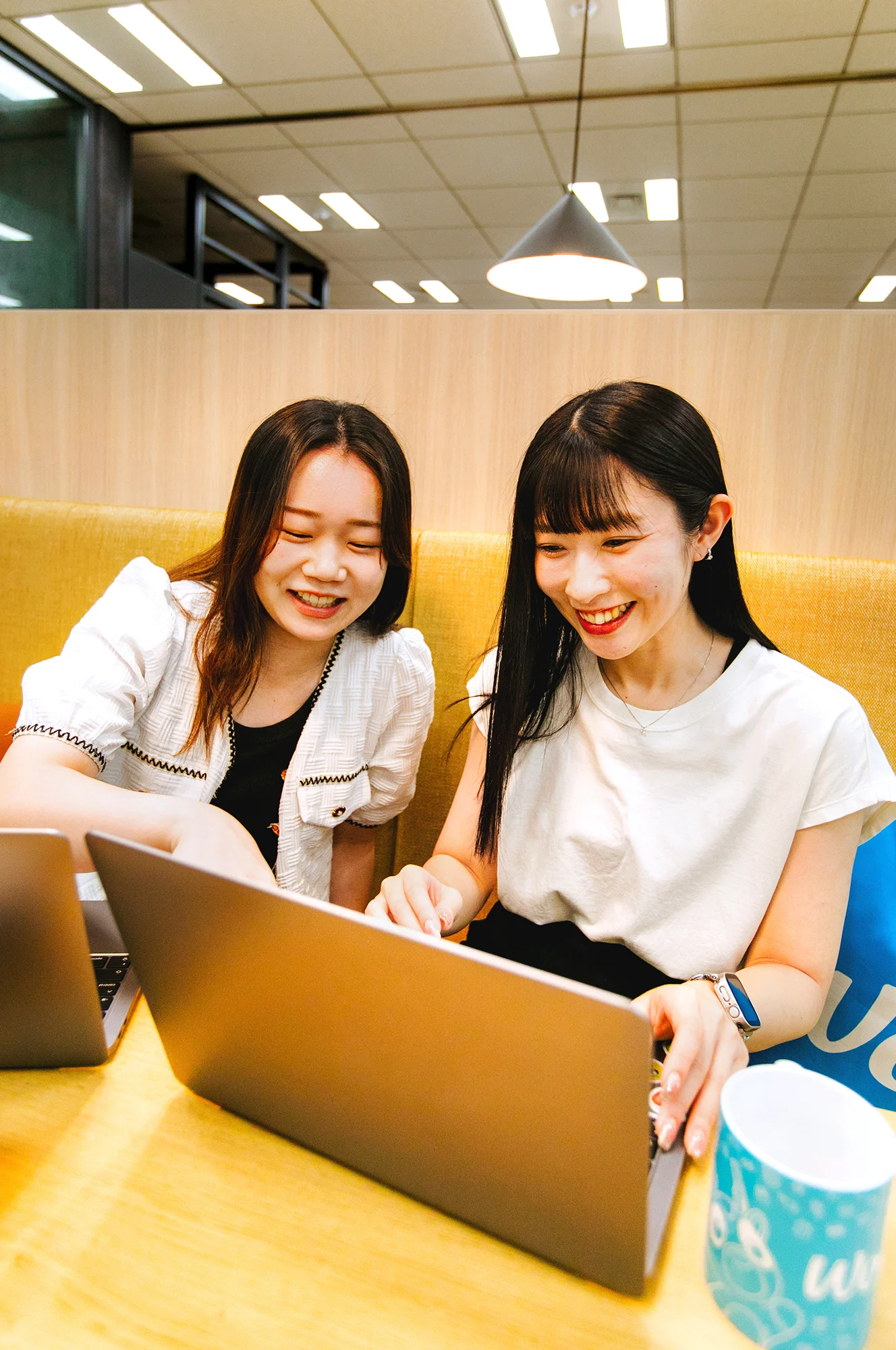 Suzuna and Rina at yellow sofa