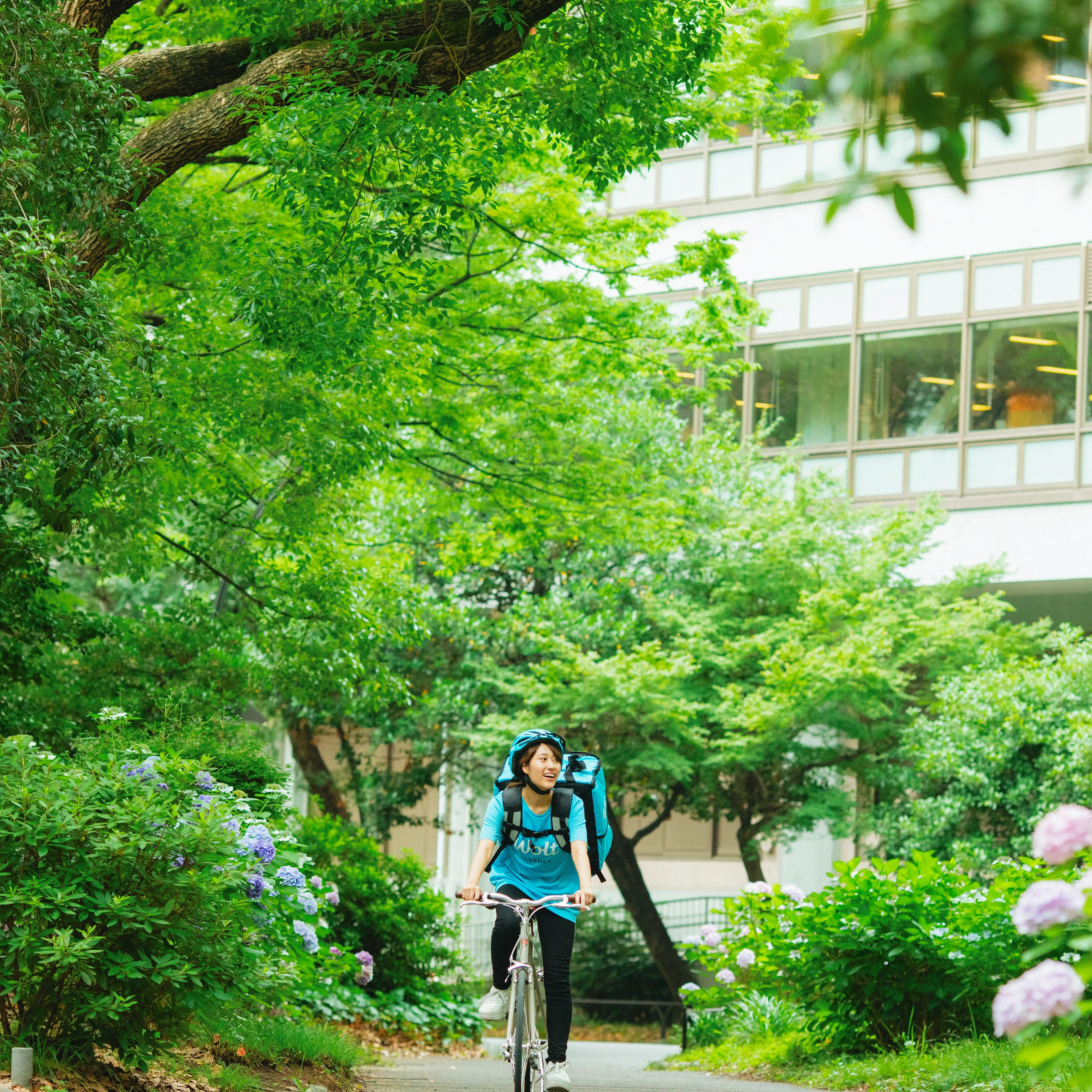 Square: Courier partner biking in a park